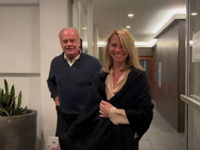 Kelsey Grammer and Kayte Walsh are walking out of a building in this picture.